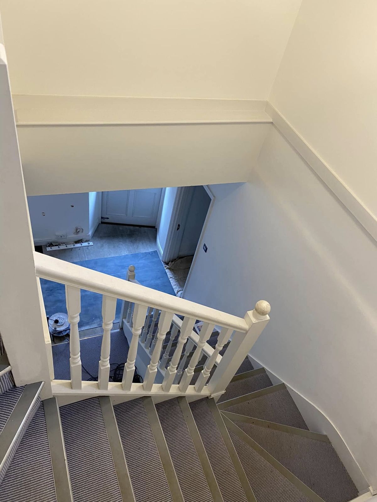 Looking down a white-spindled staircase