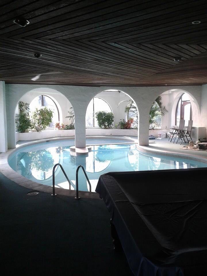 The pool room seen under its dark timber ceiling