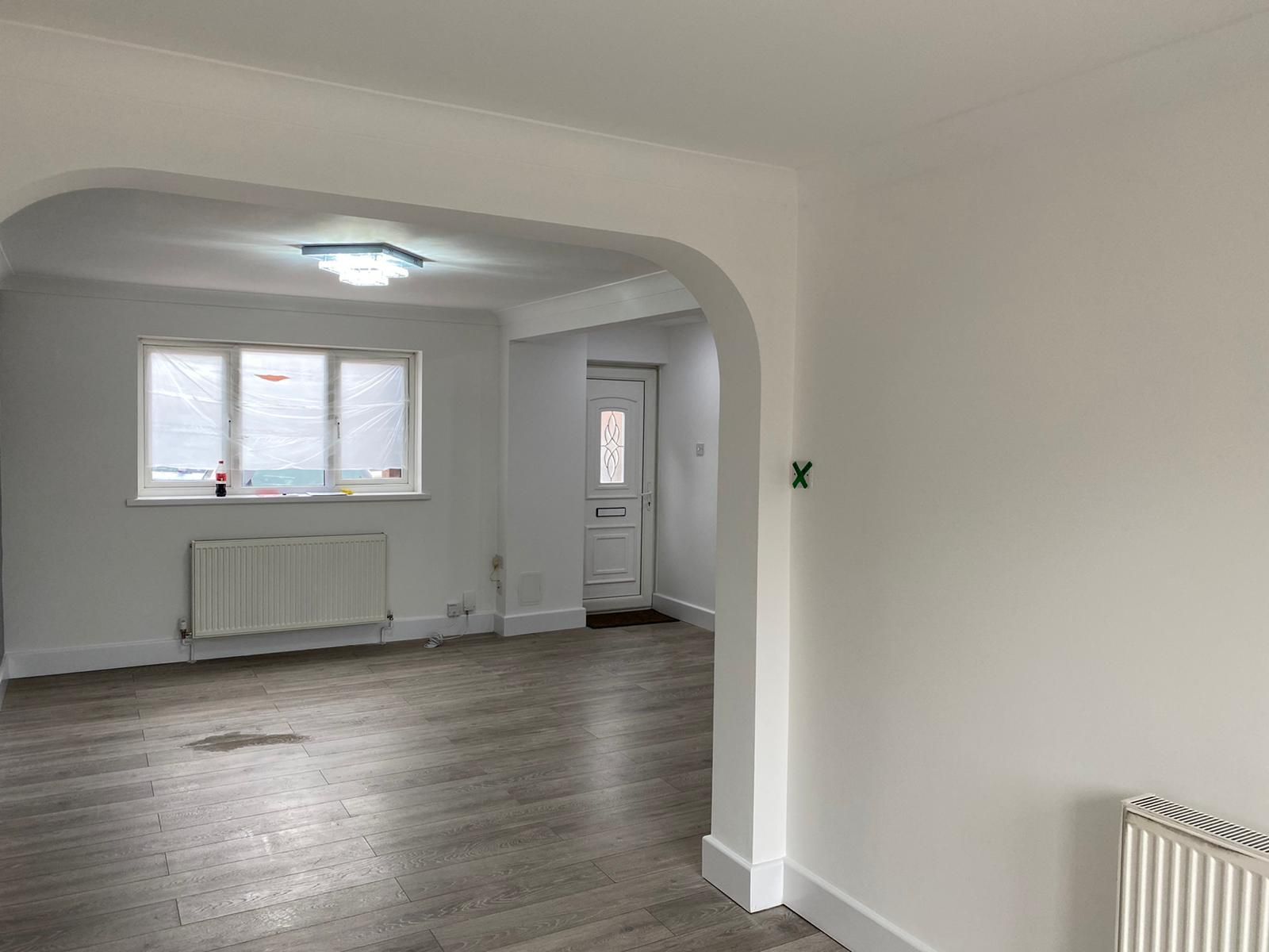 Through-lounge with an archway and white walls